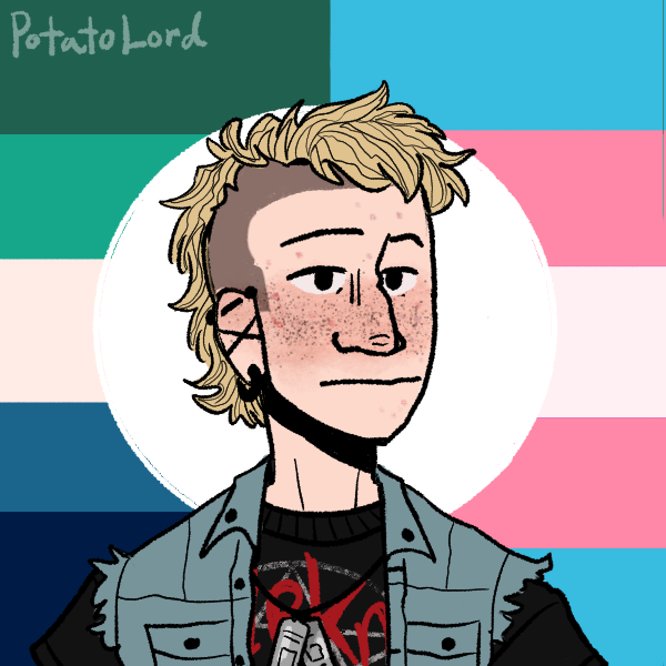 blonde guy with sides of head shaved in front of gay male and transgender pride flags