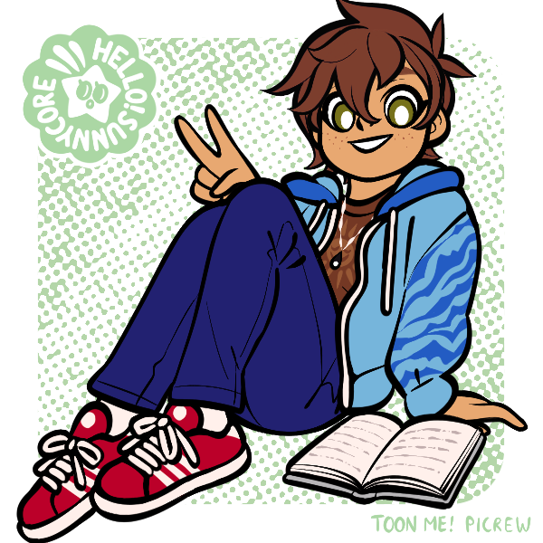 boy in blue holding up peace sign sitting next to book