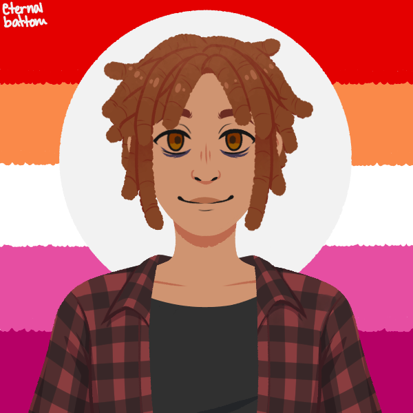 butch lesbian with short dreadlocks in front of lesbian pride flag