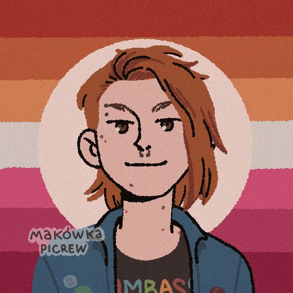 girl with half-shaved head and several face piercings in front of lesbian pride flag